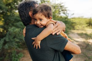 young boy hugging his father